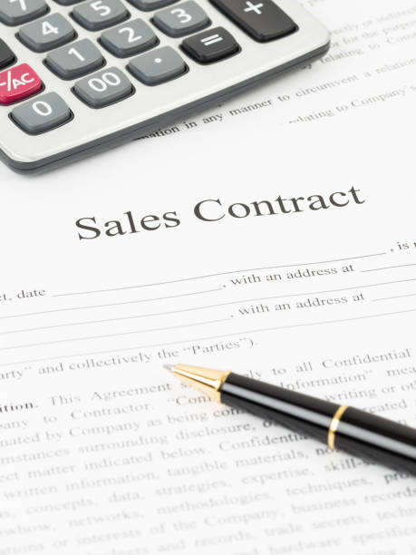 istock Sales contract document with calculator and pen 1066911592