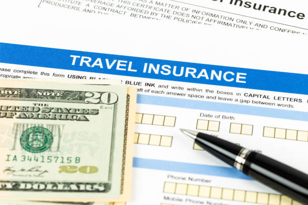 istock Travel insurance application form with pen model and dollar banknote 1066911656