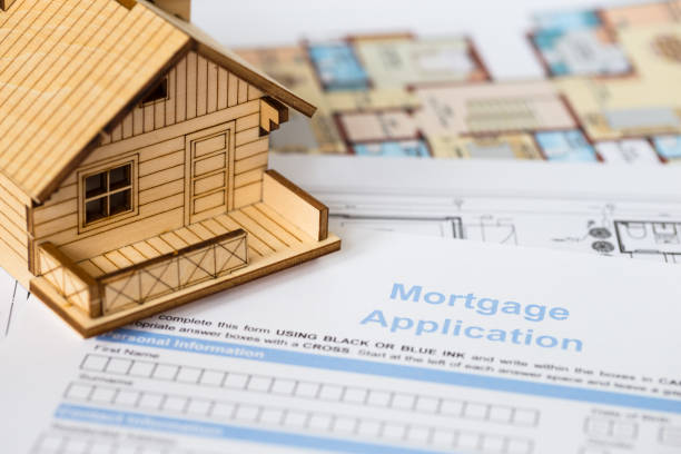 istock House mortgage application with model house and construction plan 1066911666