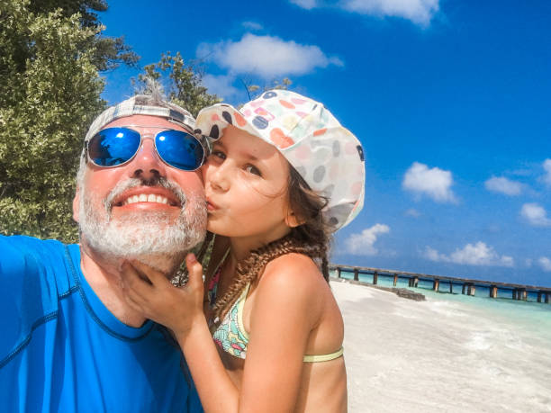 istock Young Daughter Kissing Father on Summer Vacations 1066911920
