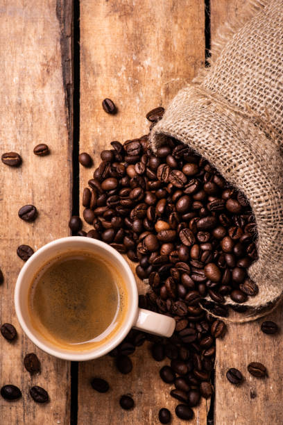 istock cup of creamy espresso with roasted coffee beans 1066912584