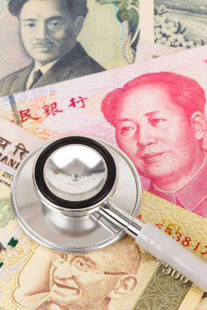 istock Stethoscope on asian banknote concept financial health check 1066912730