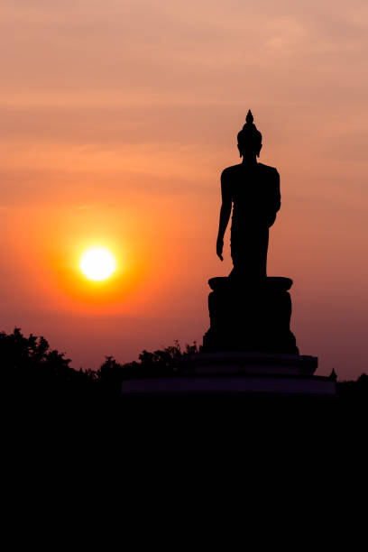 istock Statue of buddha at sunset silhouette 1066916584