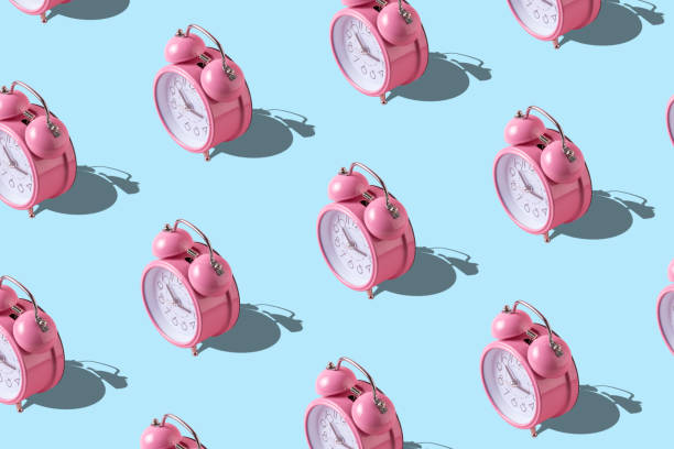 istock Creative layout of pink alarm clock's on pastel blue background. Minimal concept. 1066917252