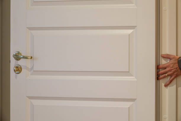 A hand about to get smashed in a door.