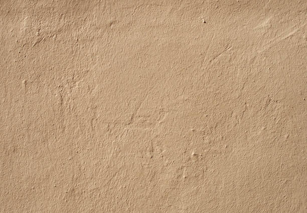 istock a beige brown rough textured grainy painted cement wall with marks and scratches 1066918422