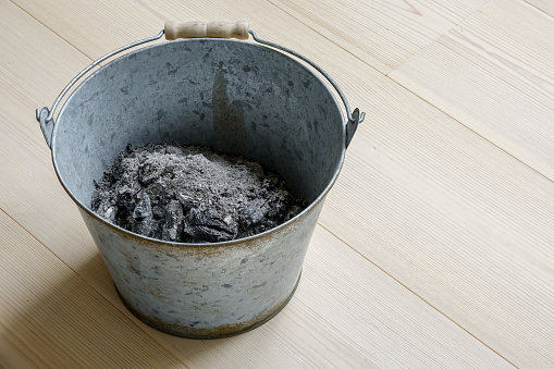 Ash in a metal bucket.