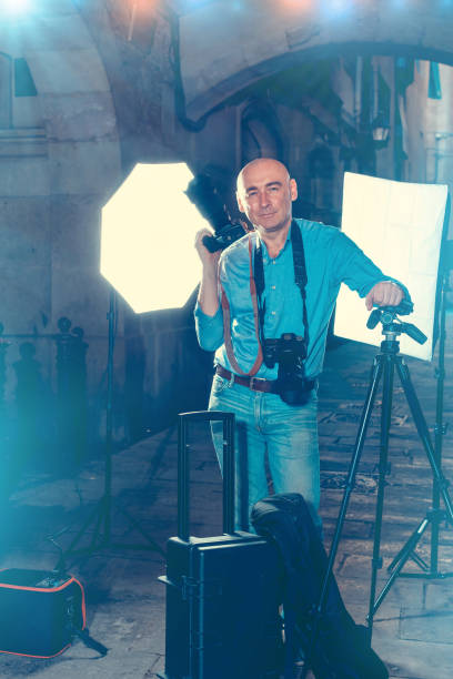 istock Photographer with camera among photo equipment 1066925068