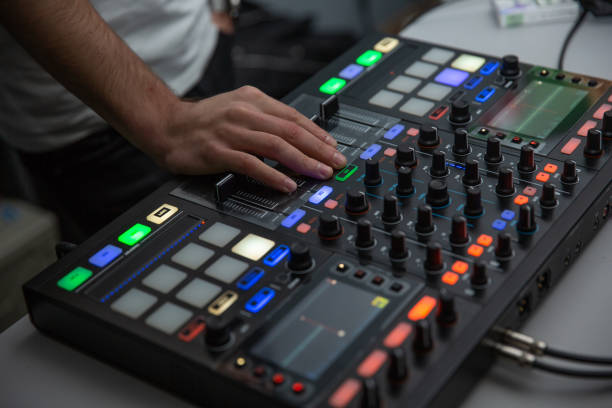 istock music, technology, people and equipment concept - man using mixing console 1066925296