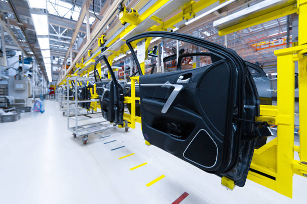 Preparation for installation of body part in car factory. door from car on production line Preparation of doors for installation in car factory. Plant for production and Assembly of new modern cars. Car door on modern production line motor vehicle stock pictures, royalty-free photos & images