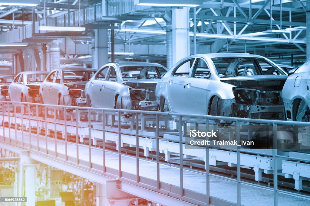 Car bodies are on Assembly line. Factory for production of cars in blue. Modern automotive industry. Blue tone Empty car bodies are on production line. Automotive production line. Blue tone. Blue tint Car Stock Photo