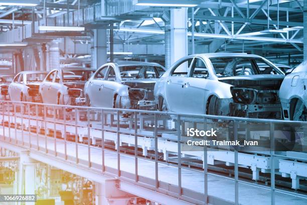 Car Bodies Are On Assembly Line Factory For Production Of Cars In Blue Modern Automotive Industry Blue Tone Stock Photo - Download Image Now