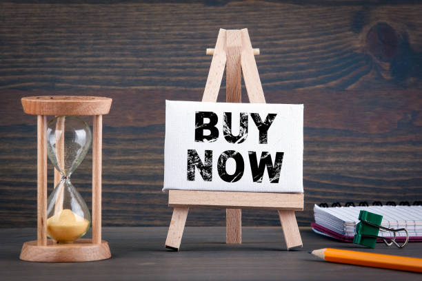 istock Buy Now. Sandglass, hourglass or egg timer on wooden table 1066927024