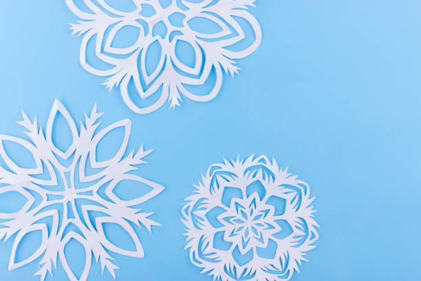 istock paper snowflakes on the blue background. copy space 1066927450