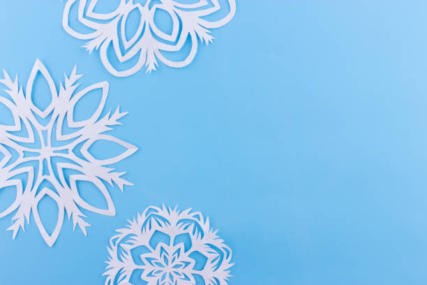 istock paper snowflakes on the blue background. copy space 1066927456