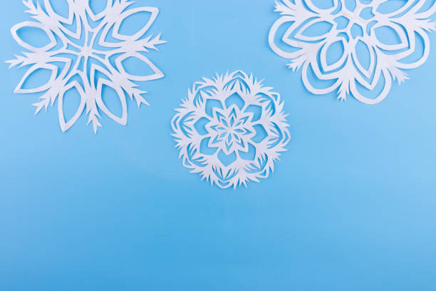 istock paper snowflakes on the blue background. copy space 1066927460