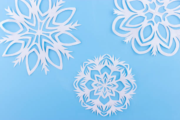 istock paper snowflakes on the blue background. copy space 1066927482