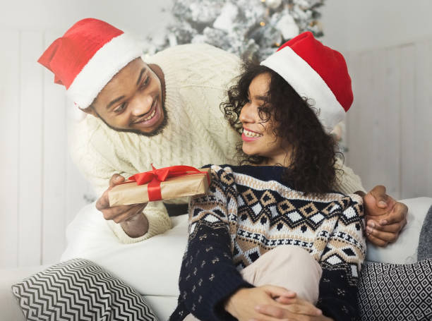 istock Young man giving Christmas present to his girlfriend 1066933294