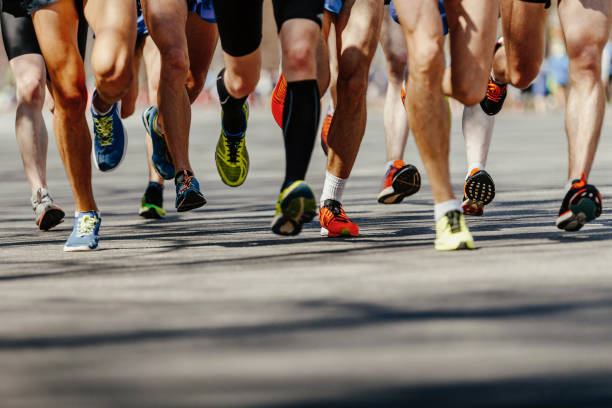 istock legs group men runners running on asphalt road 1066935970