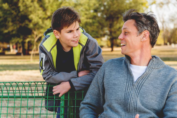 istock Father and son having a talk in park 1066936002