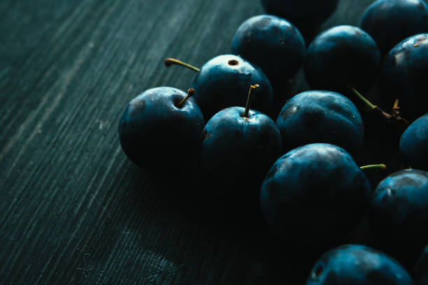 istock many fresh plums on black background close up 1066941636