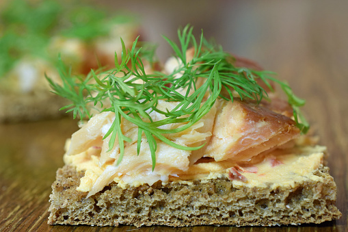 Delicious Canape with smoked arctic char, cream cheese and dill toppings on rye bread.