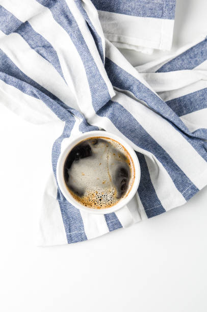 istock Cup of coffee on a towel with a blue stripe 1066943234