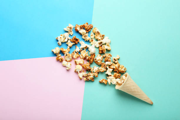 istock Caramel popcorn in waffle cone on colorful background 1066946220