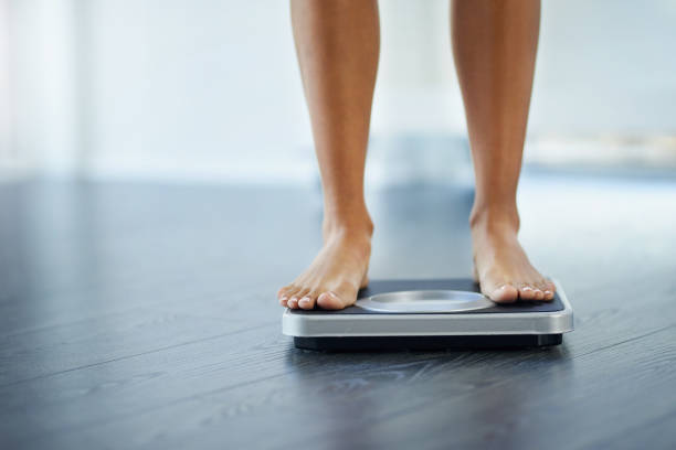 need to lose a few pounds? - weight scale imagens e fotografias de stock