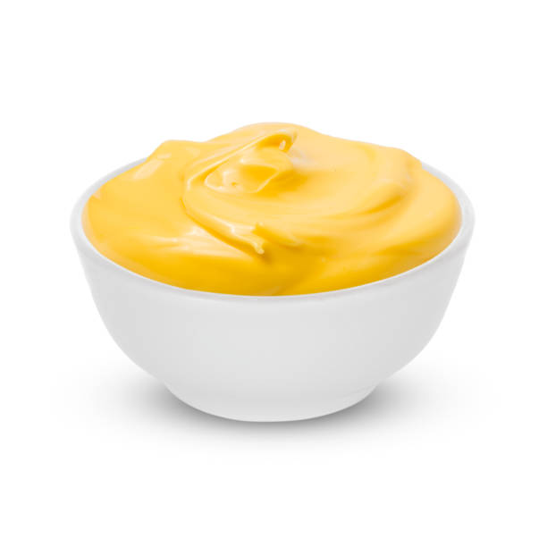 One Bowl with tasty cheese sauce on white background Bowl with cheese sauce on white background cheese sauce stock pictures, royalty-free photos & images