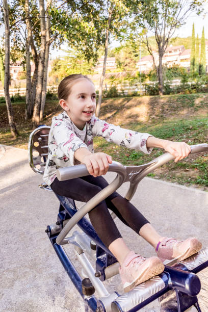 istock Girl Exercising on Exercise Equipment at Park 1066951158