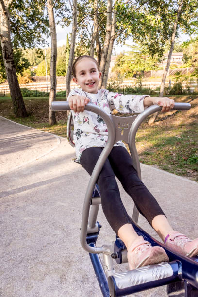 istock Girl Exercising on Exercise Equipment at Park 1066951282