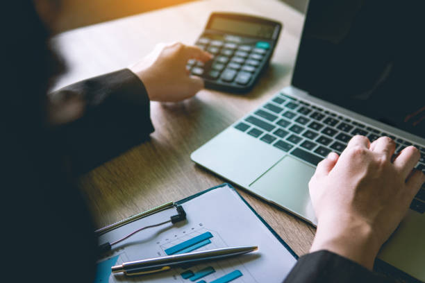 istock Business financial manager using calculator and laptop for analyzing finance graph data in office. successful concept. 1066954902