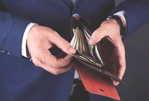 istock young business man hand  money with  wallet 1066955756