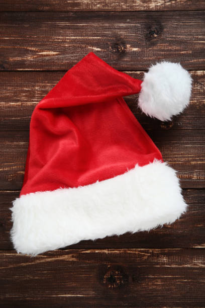 istock Santa claus hat on brown wooden table 1066956270