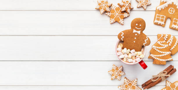 Christmas gingerbread in cup of cocoa on white background