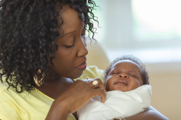 istock Mother holding her newborn at home 1066964728
