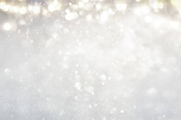 istock glitter vintage lights background. silver and light gold de-focused. 1066965698