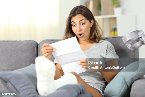 Surprised Disabled Girl Reading Notification Stock Photo - Download Image Now - Financial Bill, Healthcare And Medicine, Surprise