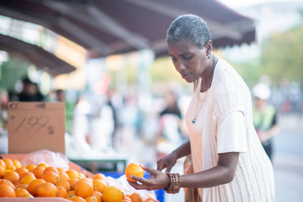 istock Senior woman shopping for oranges 1066968680