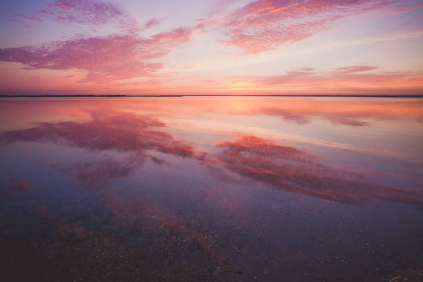 istock Colorful beautiful cloudy sunset over ocean surface 1066972846