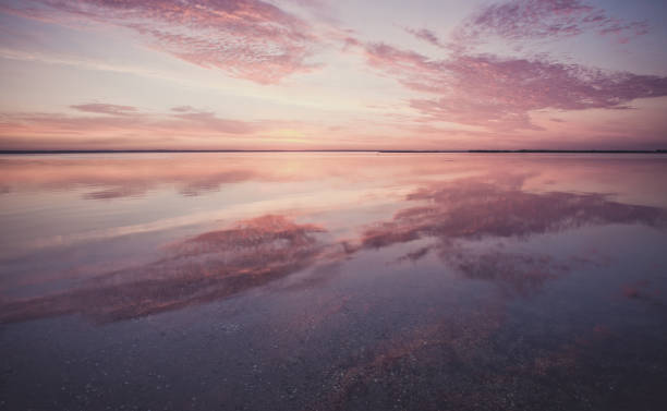 istock Colorful beautiful cloudy sunset over ocean surface 1066972888