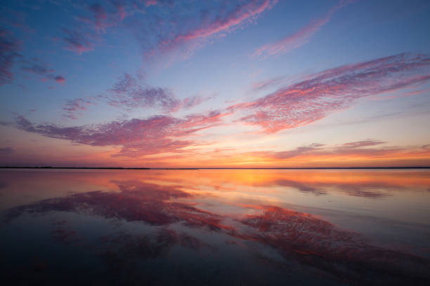 istock Colorful beautiful cloudy sunset over ocean surface 1066972968