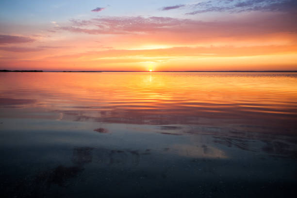 istock Colorful beautiful cloudy sunset over ocean horizon 1066972976