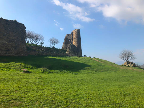 istock Ruins of an old fortress against the sky, panoramic view. Spring, green fields 1066975048