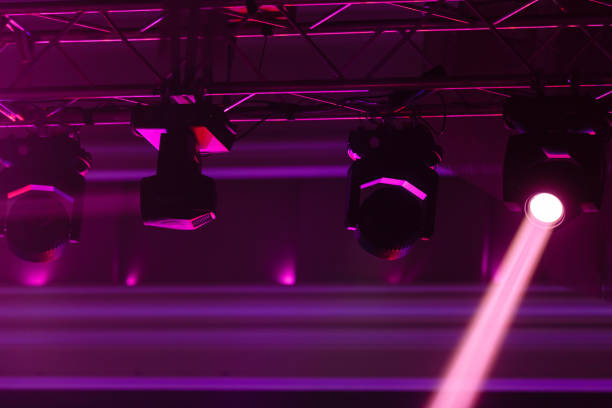 istock Light projectors at night party, pink light stream 1066975508