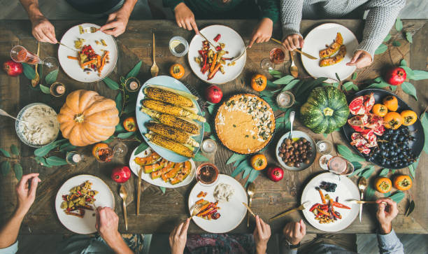 istock Friends eating at Thanksgiving Day table with vegetarian snacks 1066977840