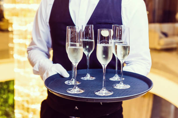 professional waiter in uniform is serving wine - tray glove butler white imagens e fotografias de stock