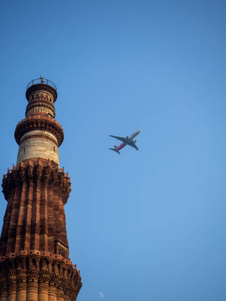 istock Airplane near a high tower 1066982114