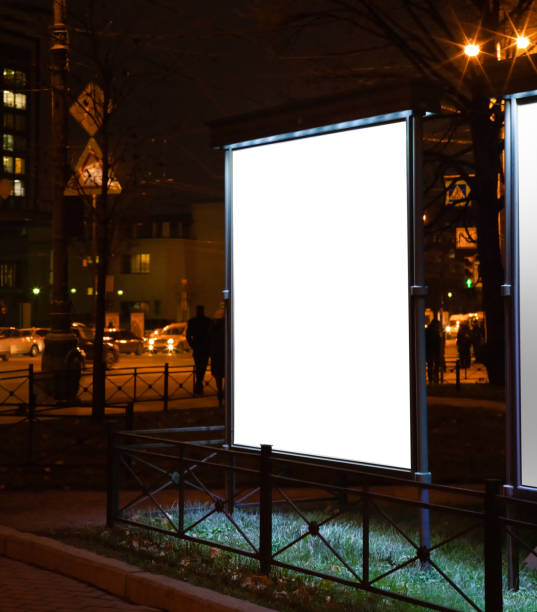 istock billboard for sticking posters. glowing in the night city. consecrated with embedded light. mockup with white field 1066982248